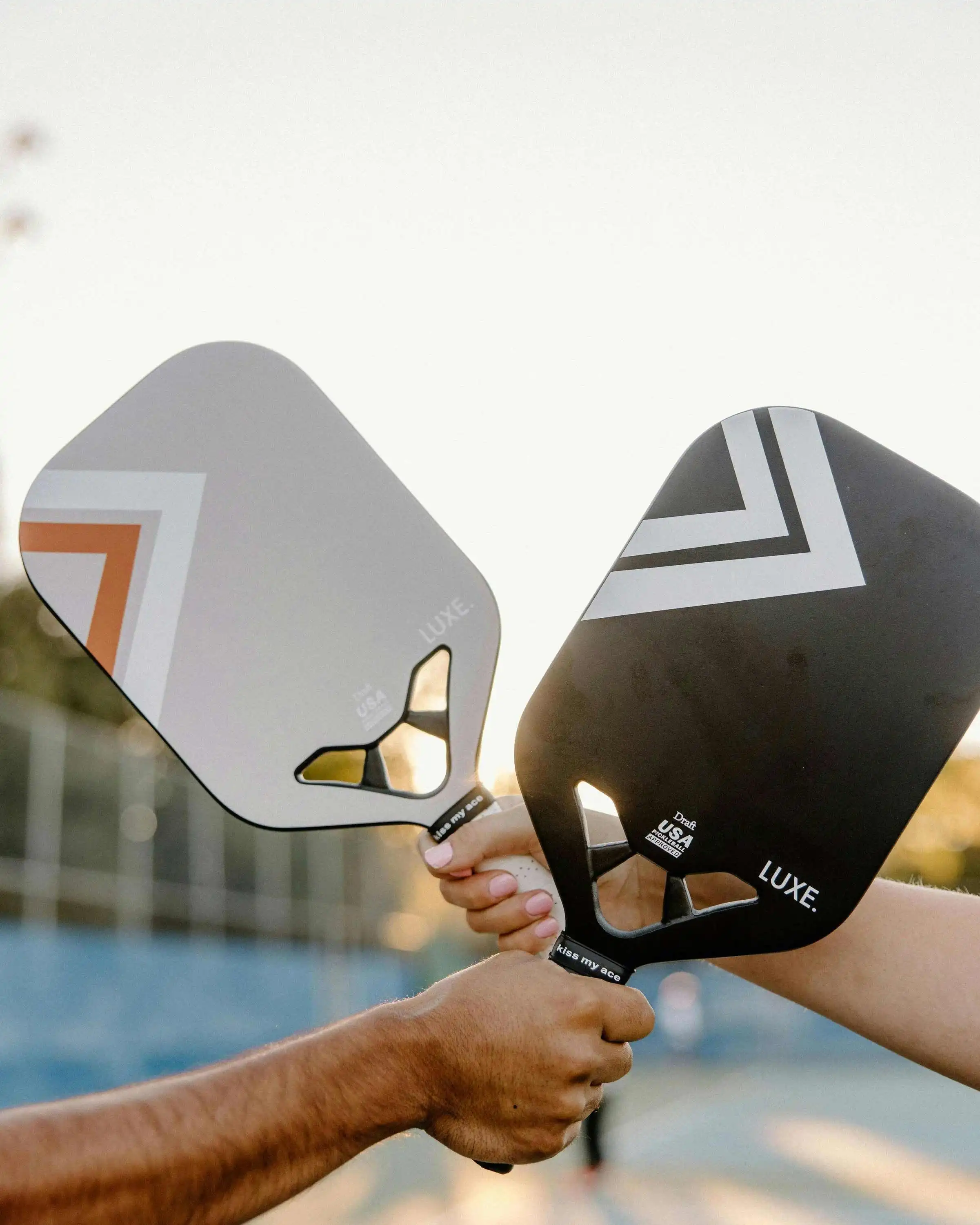Two Pickleball paddles crossing